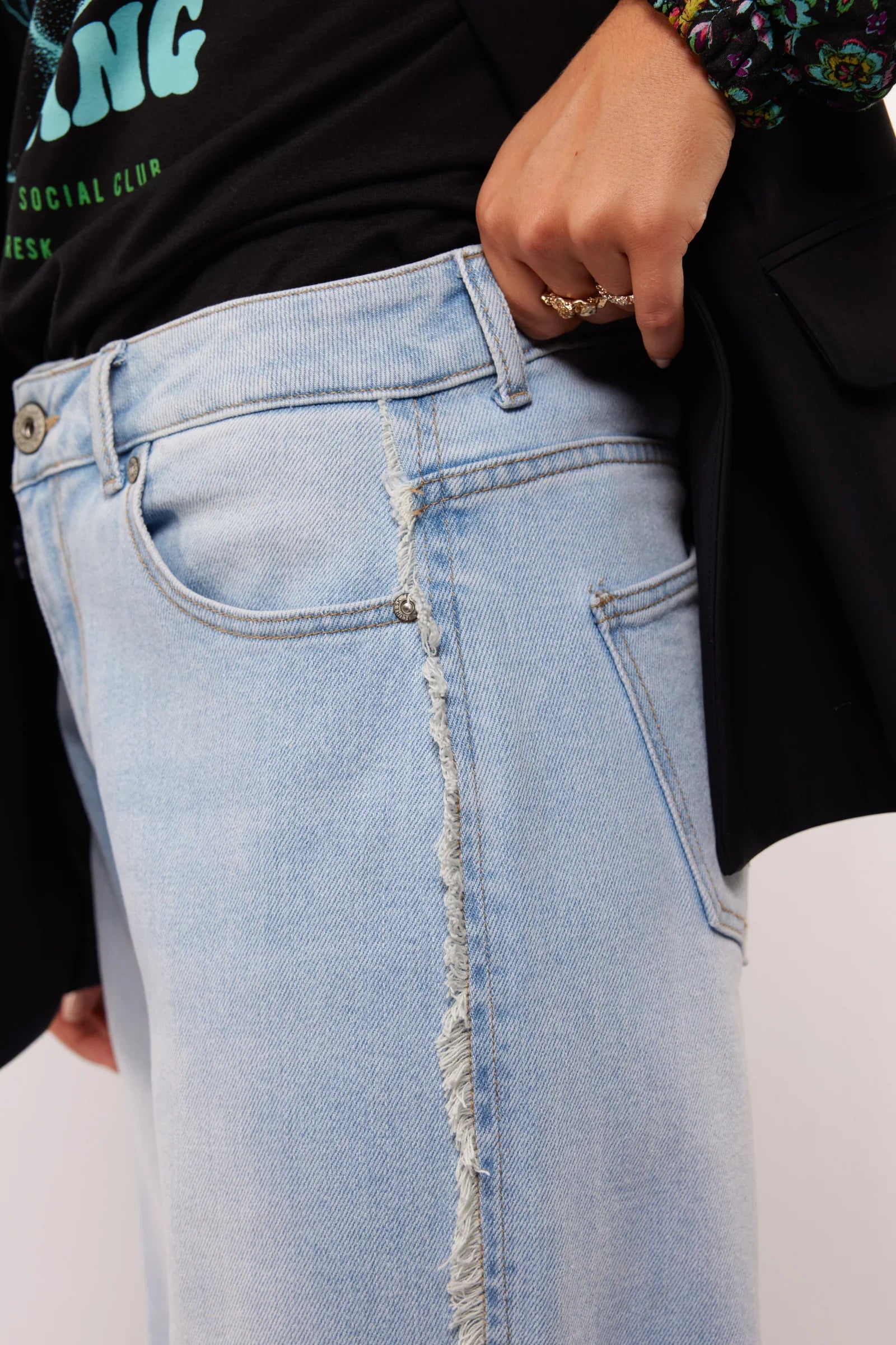 Close-up van onafgewerkte zijnaad van de Fluresk Celin Pants in lichtblauwe denim.