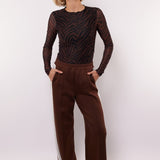 model draagt de mairen pants en de lawrence top van fluresk in het bruin