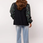 Achteraanzicht van de Fluresk Celin Pants in lichtblauwe denim met wijde pijpen.