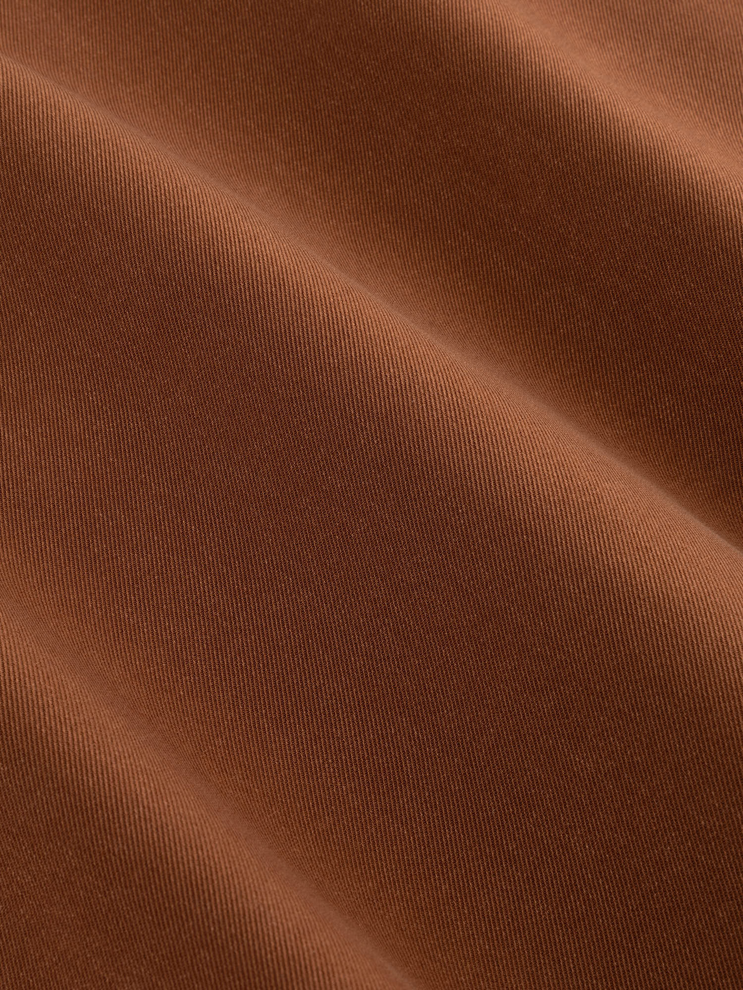 Detailopname van de stof van een jasje in camel | Ydence Davis | Jo&Co Club