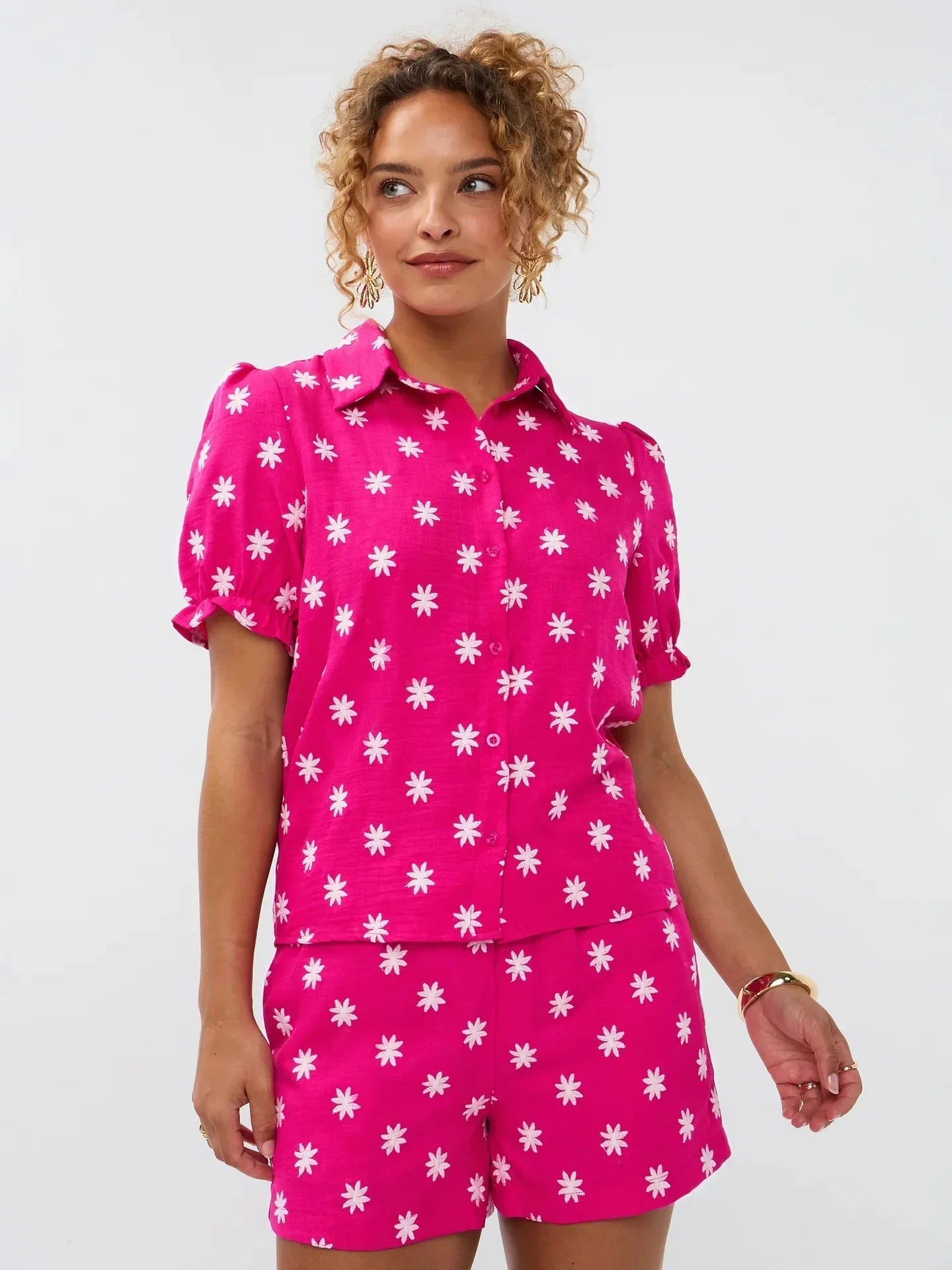 Model draagt de Vievienne blouse, een fuchsia blouse met witte bloemenprint en bijpassende short van Ydence.