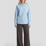 Model in gestreepte blouse Fluresk Joan met kraag en brede manchetten, voorkant | Jo&Co Club