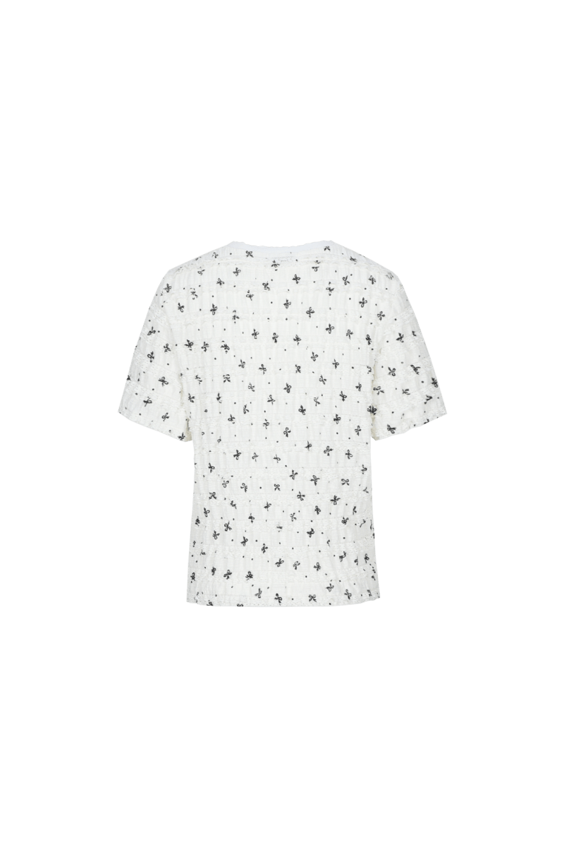 Fluresk top in Offwhite/Black – achterkant van witte top met zwarte strikjesprint | Jo&Co Club