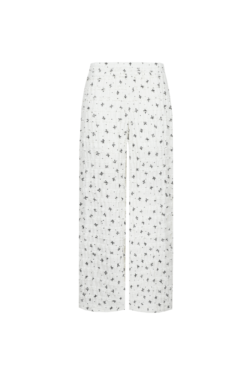 Broek pants Offwhite/Black – Witte broek met wijde pijpen en print van zwarte strikjes | Jo&Co Club