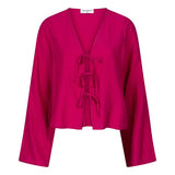 Een model presenteert een levendig fuchsia playsuit tegen een effen beige achtergrond | Lofty Manner Maeve | Jo&Co Club