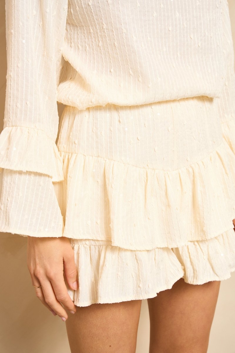 Lofty Manner Top Pia crème – Crèmekleurige top met ruffelmouwen en lovertjes | Jo&Co Club