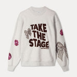 Productfoto van de grijze sweater plat gefotografeerd, met tekstprint en pailletdetails.