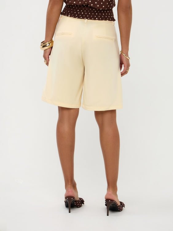 Achteraanzicht van model in soft yellow Ydence Bermuda Jolijn met polkadot crop-top | Jo&Co Club