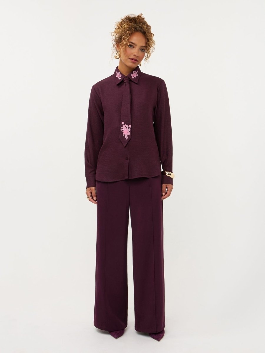 Model in pruimkleurige blouse met geborduurde bloemen Ydence Carrie | Jo&Co Club