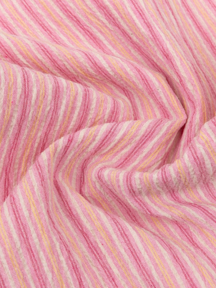 Een close-up van een gedrapeerde stof met een verticaal strepenpatroon | Ydence Lola | Jo&Co Club