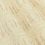 Een close-up detailfoto van een zachtgele stof | Ydence Diana | Jo&Co Club